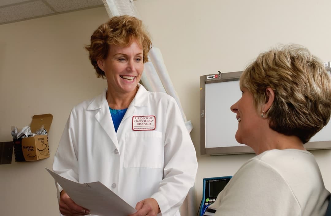 A chiropractor consulting with a patient in a modern clinic, highlighting the importance of patient retention and care.
