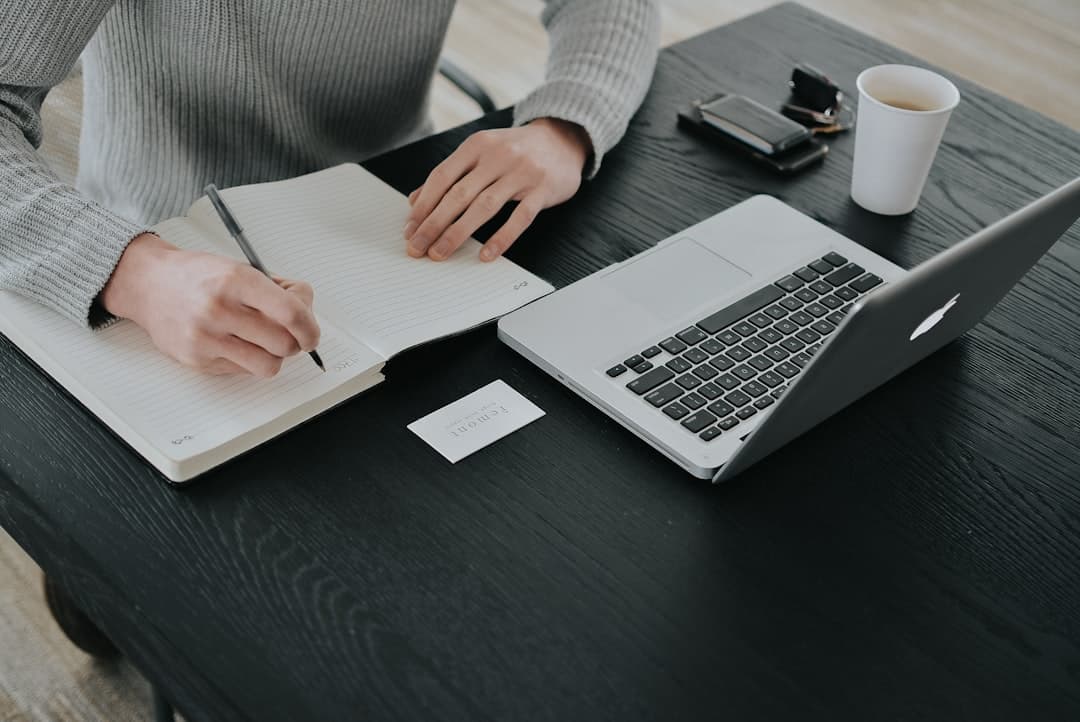 A person working on a laptop in a cozy home office, representing the cost-effective nature of DIY marketing for private practices.