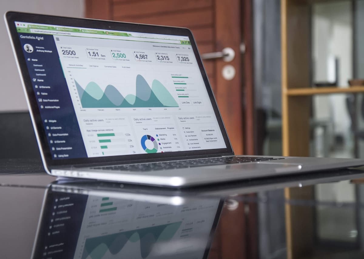 Laptop on a desk displaying analytics dashboards for reviewing paid search and Google Ads performance