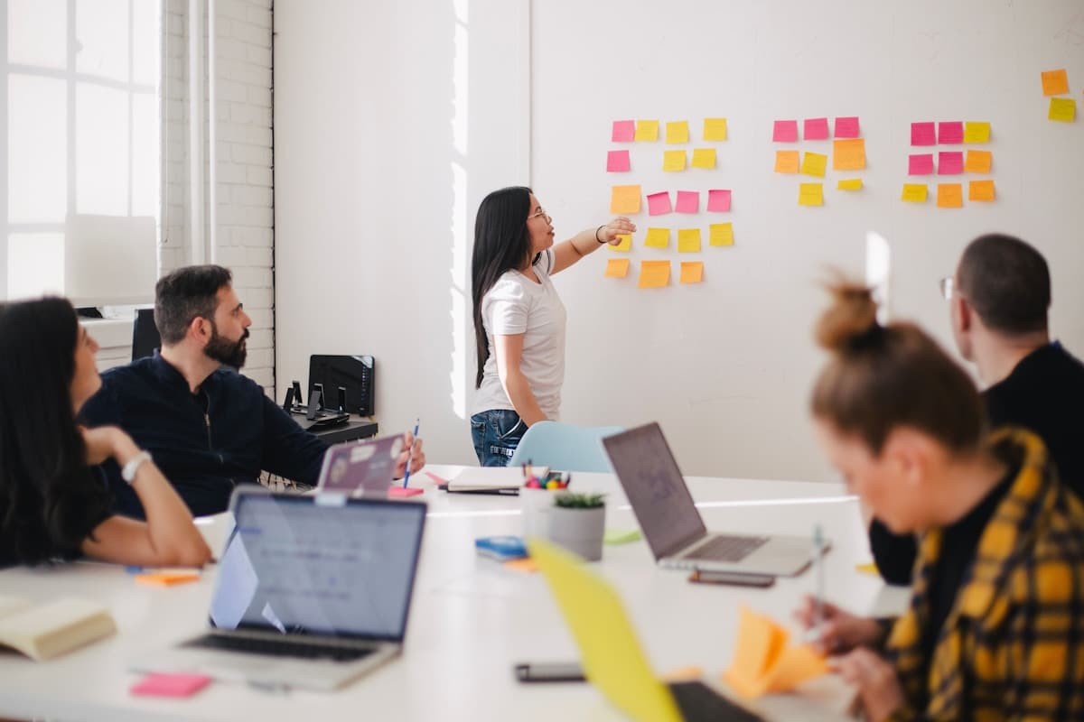 Team reviewing growth metrics together at a conference table in a bright office