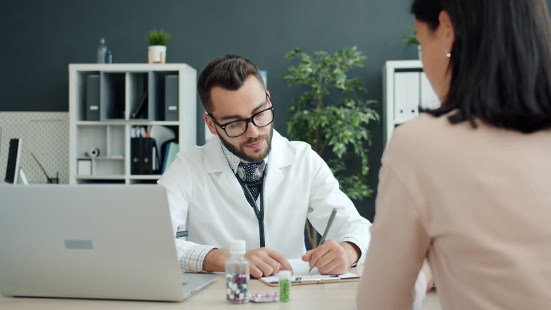 A diverse group of therapists in a meeting room discussing strategies for hiring associate therapists in a practice.
