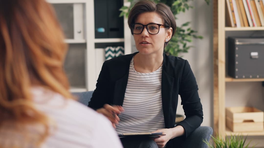 An occupational therapist engaging with a client, highlighting the importance of explaining fit and process on a website.