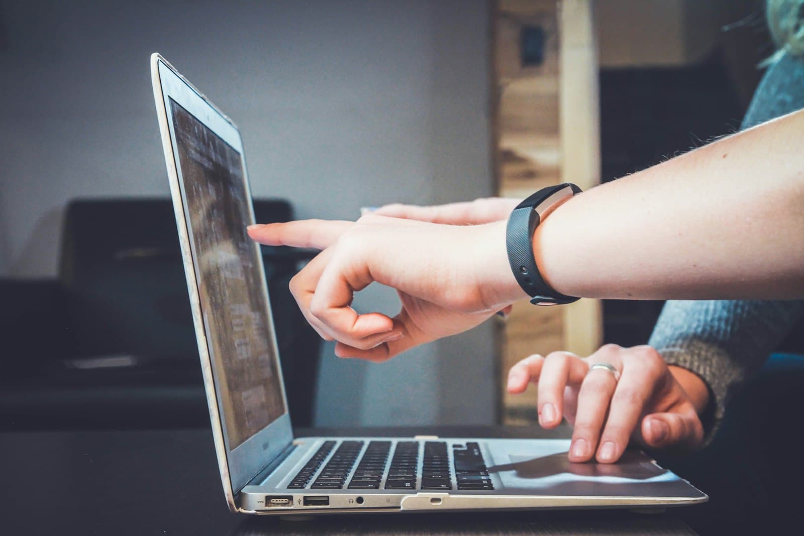 Two people reviewing a strategy document on a laptop for private practice marketing