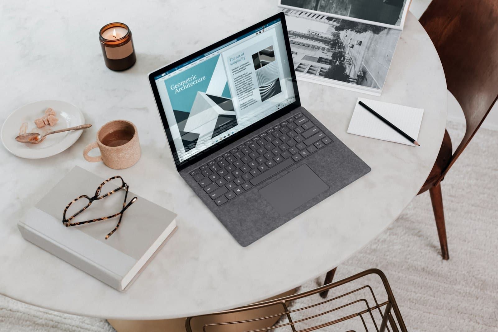 Laptop and notebook used to plan how to market a private practice