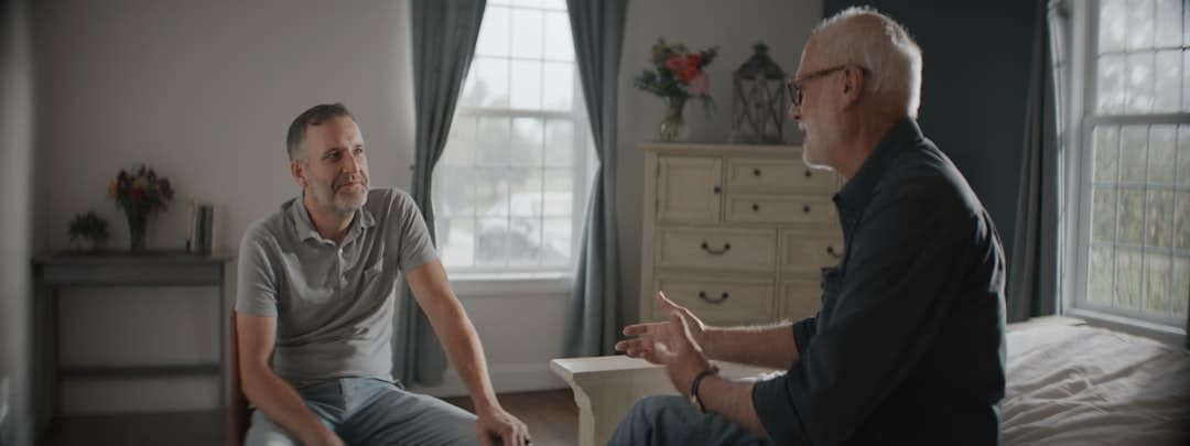 Physiotherapist consulting with a patient in a therapy room, emphasizing the importance of retention and rebooking.