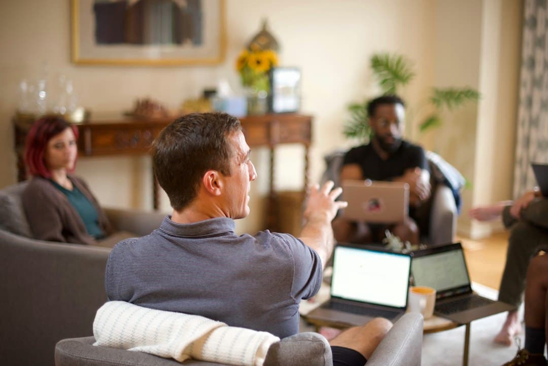 A diverse team of therapists in a meeting room discussing strategies for multi-location clinic marketing.