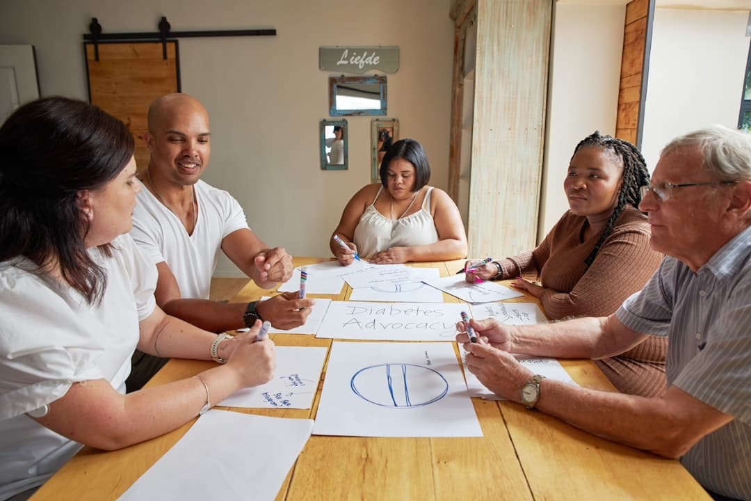 A team of healthcare professionals in a meeting, discussing strategies for marketing private pay therapy practices effectively.