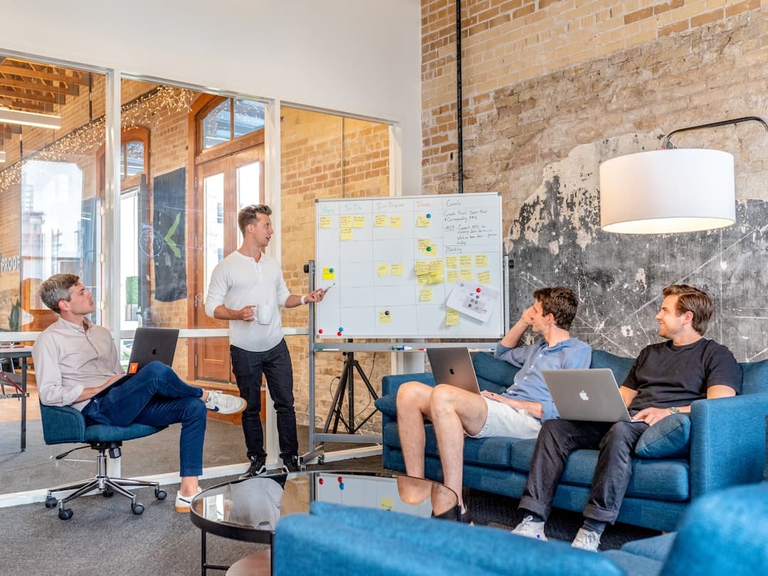 A group of professionals in a meeting room discussing strategies, representing setting up a retargeting campaign.