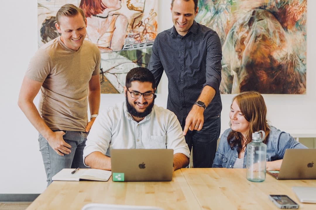 A diverse team of marketing professionals discussing strategies in a modern office setting, ideal for a therapist marketing agency.