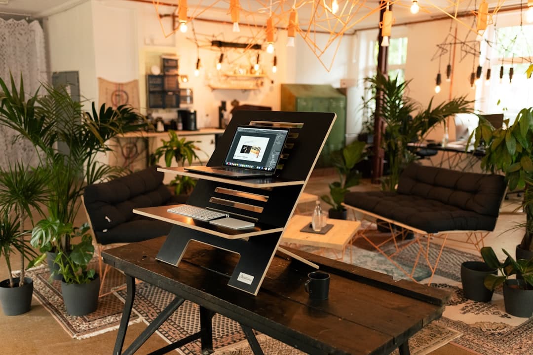 A modern therapist's office with a welcoming design, featuring a comfortable seating area and a desk with a laptop.