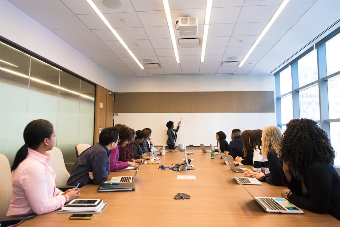 A team of professionals discussing strategies in an office, representing message alignment for effective landing pages.