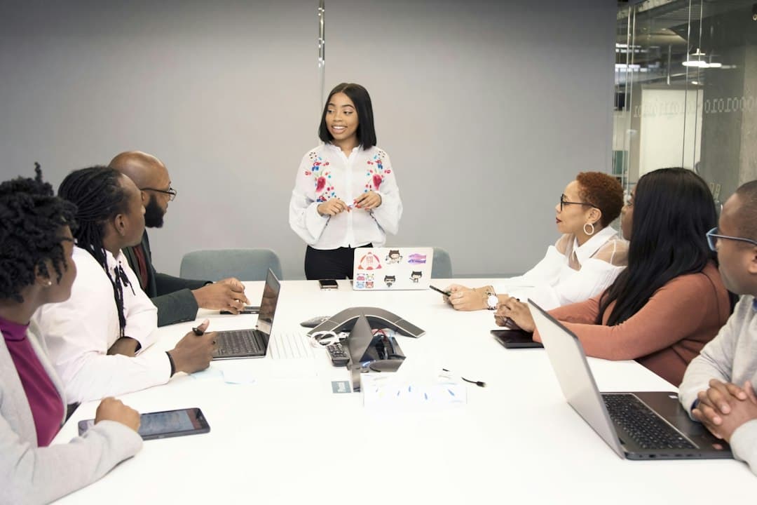 A team of therapists in a meeting discussing practice growth strategies and KPI management.