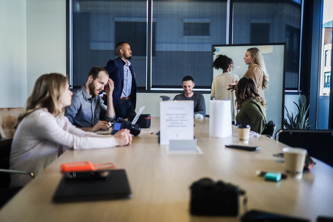 A team of professionals brainstorming around a table, discussing strategies for structuring service pages effectively.