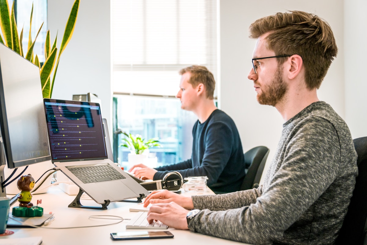 Bright open-plan office with rows of desks suggesting professional collaboration and referral networks