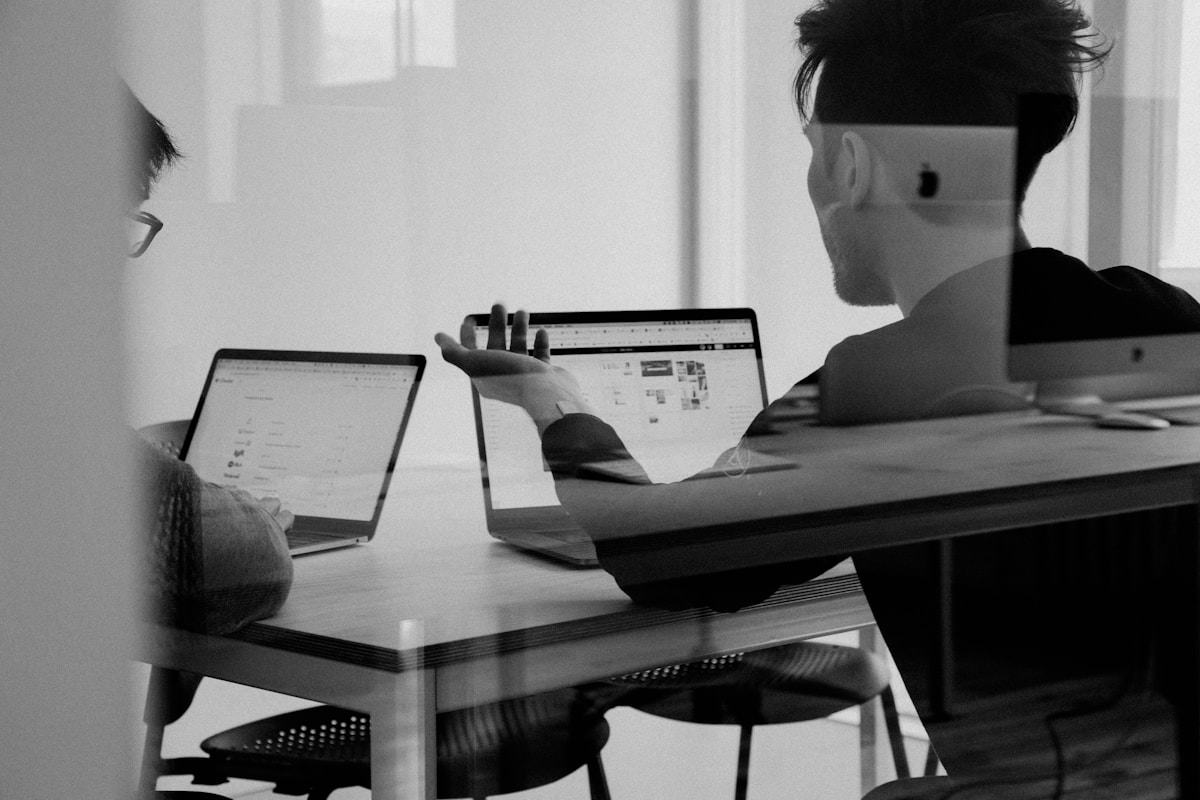 Team gathered around a laptop and whiteboard planning local search visibility for a private practice website